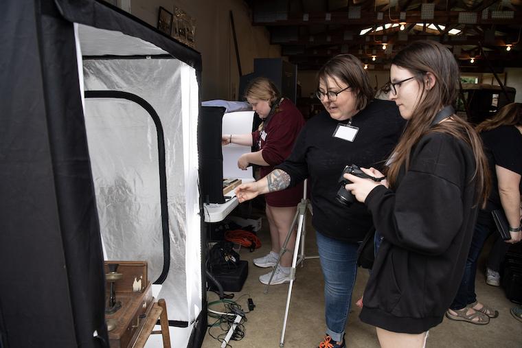 Washington College Professor Sara Clarke - De Reza helps students participating in the Digital Scholarship in Museum Partnership project at the Kent Museum. 